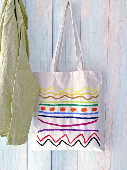 Neutral toned tote slung over a shoulder for a weekend farmer's market trip.