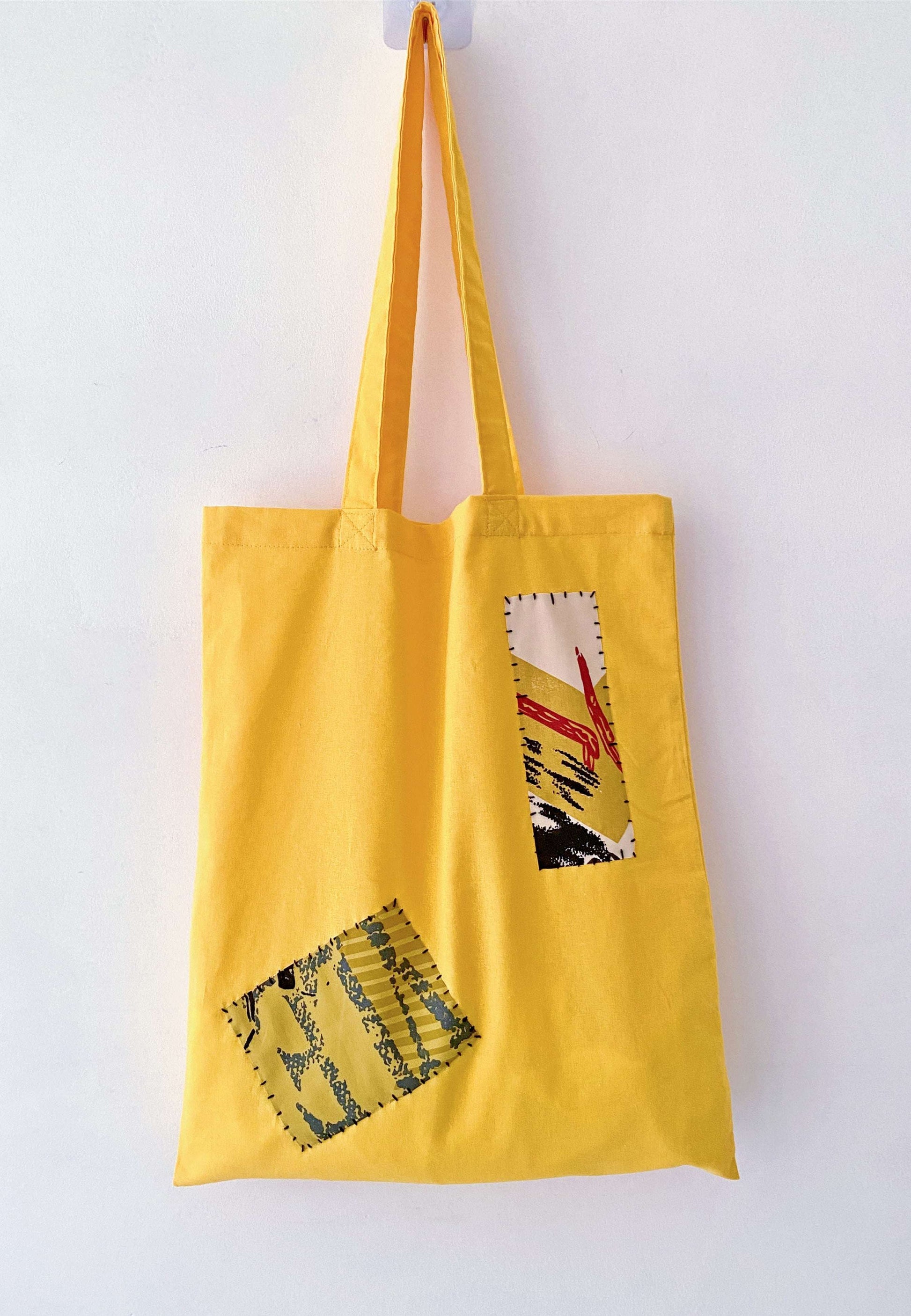 Person using a spacious unstructured tote for carrying books and a laptop