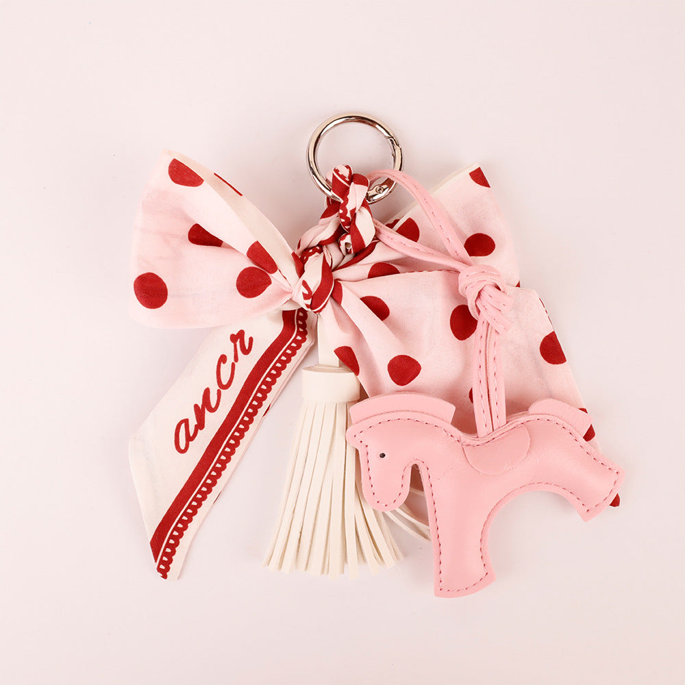 Polka dot bow tassel accessory for a small handbag