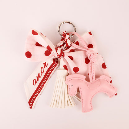 Polka dot bow tassel accessory for a small handbag