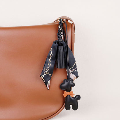 A stylish animal accent attached to a handbag handle