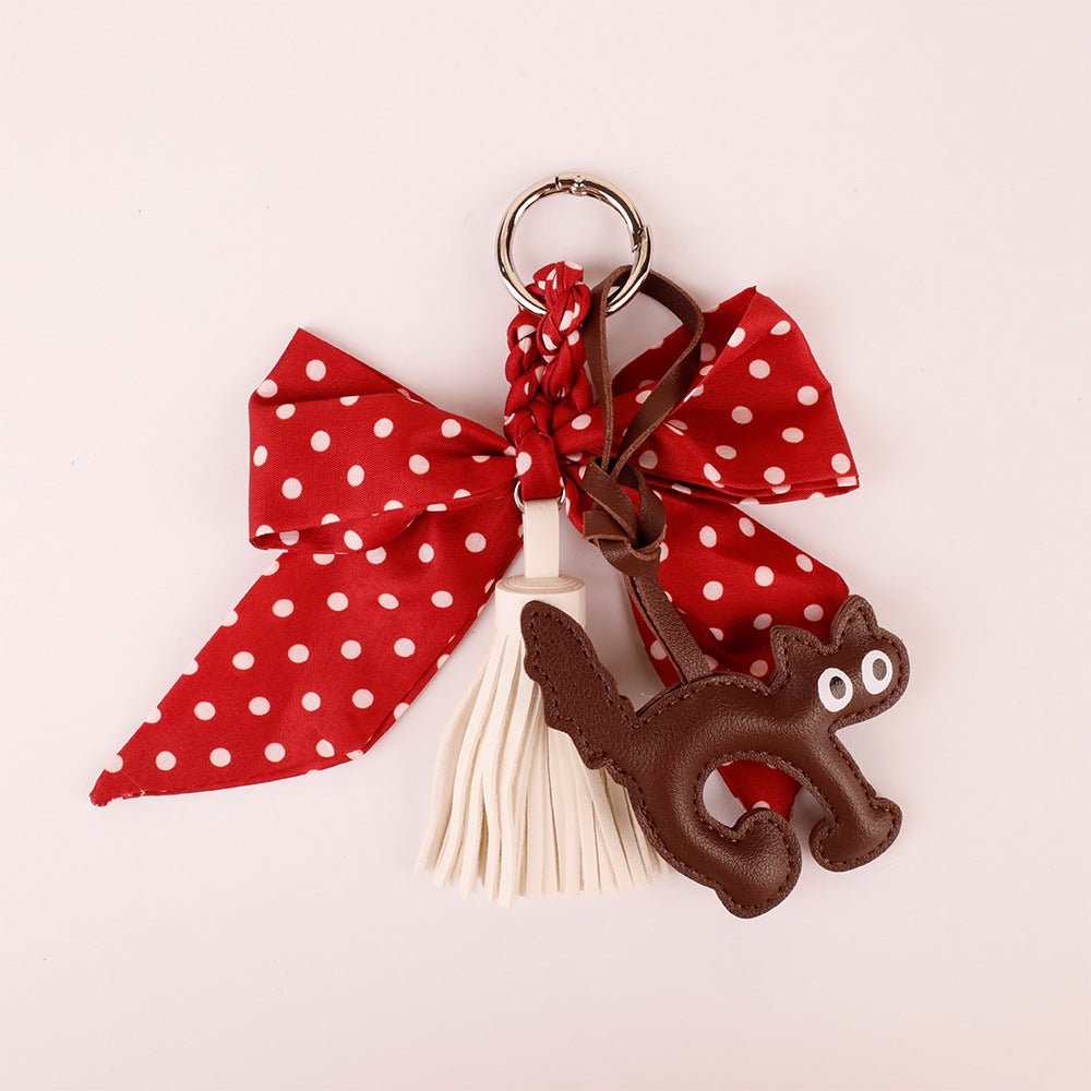 Red bow accessory for personalizing a plain handbag