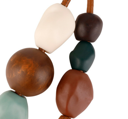 Distinctive handmade charm styled with a casual handbag