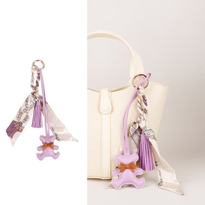Cute bear keychain attachment styled on a structured executive work tote
