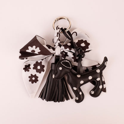Handmade monochrome silk bow charm close up detail on brass clasp