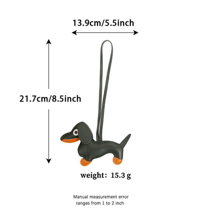 Artisanal dachshund keychain accessory dangling from a luxury leather tote
