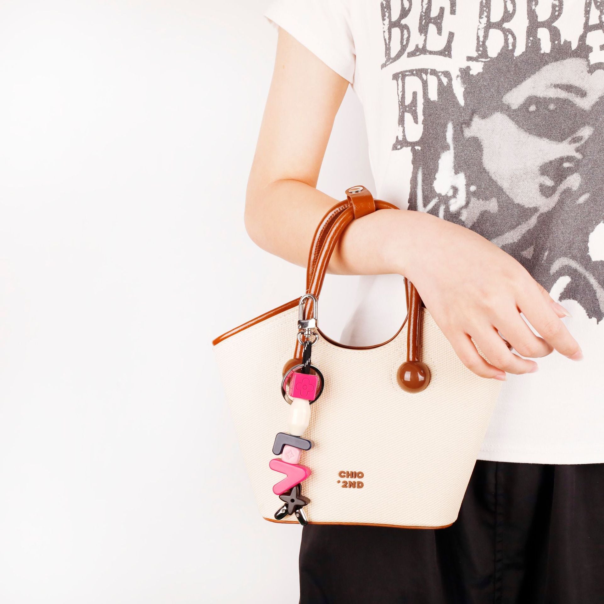 Bright resin letter charm used as phone wrist strap
