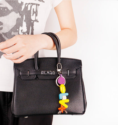 Personalized initial keychain attached to everyday purse