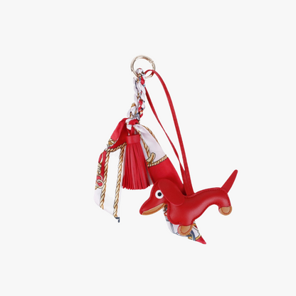 Handcrafted brown leather dachshund charm clipped to a designer canvas tote bag