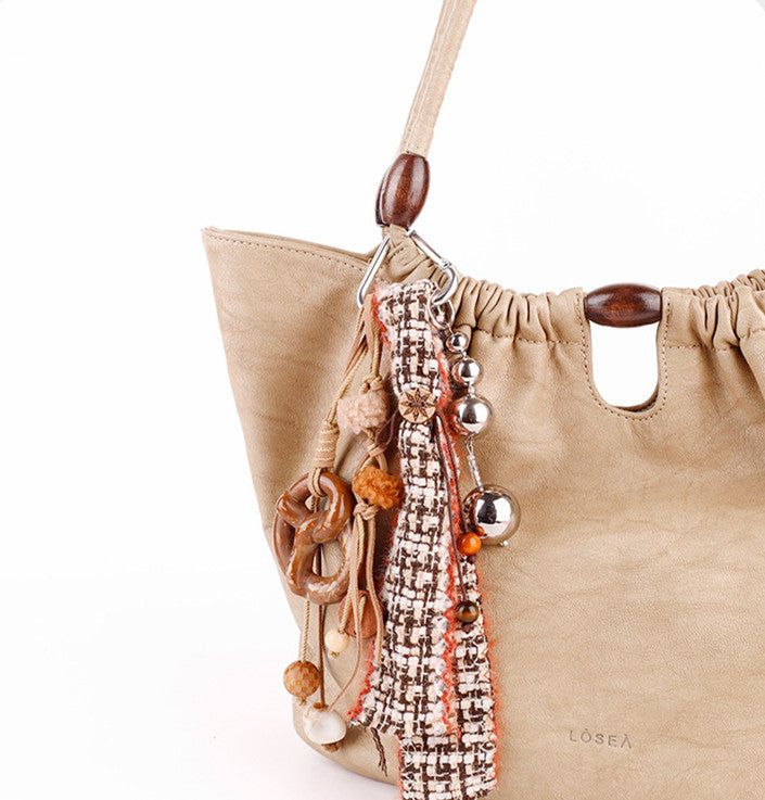Small woven bag decoration with wooden bead details