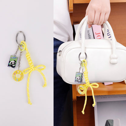 Eye-catching yellow athletic charm paired with a sporty nylon tote bag