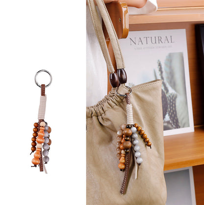 Woven bead pendant styled with a casual everyday tote