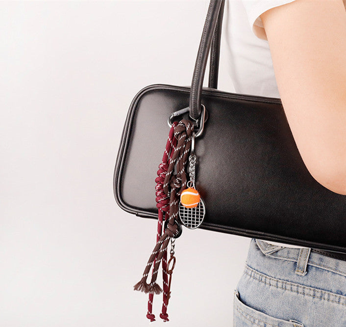 Sporty bag charm clipped to a casual backpack