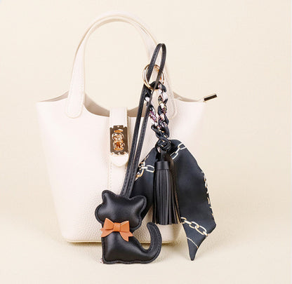 Playful cat bag accessory with tassel detail