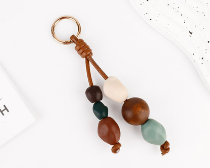 Small handcrafted ornament attached to a bag handle