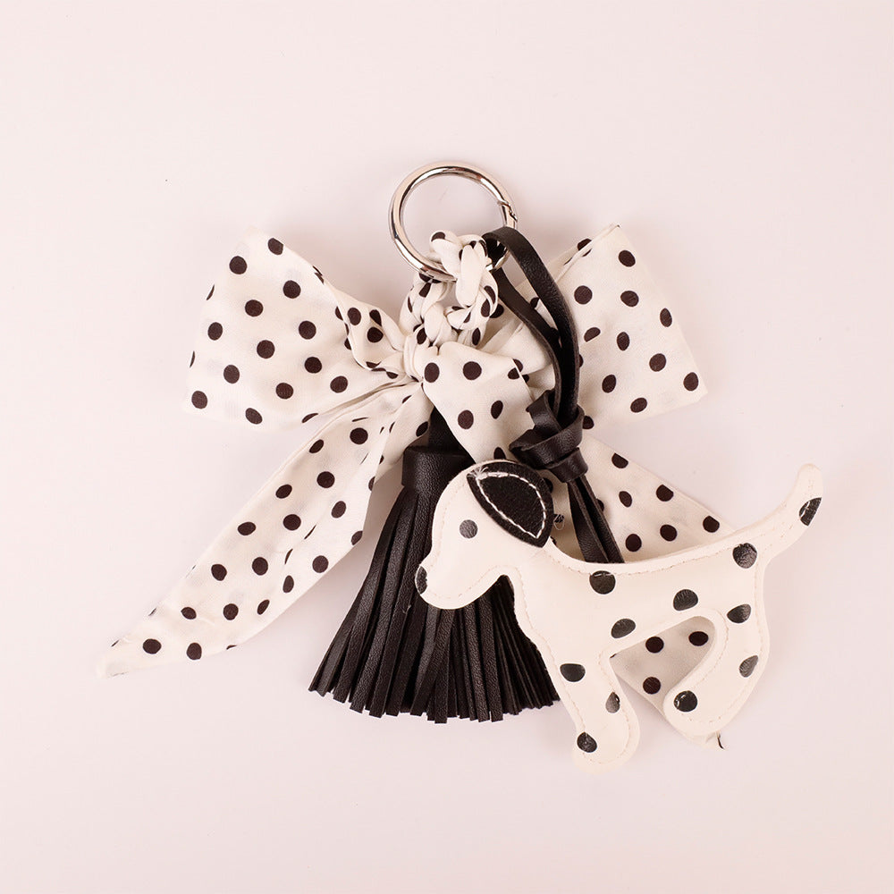 Contrast black and white scarf pendant clipped to a designer leather satchel