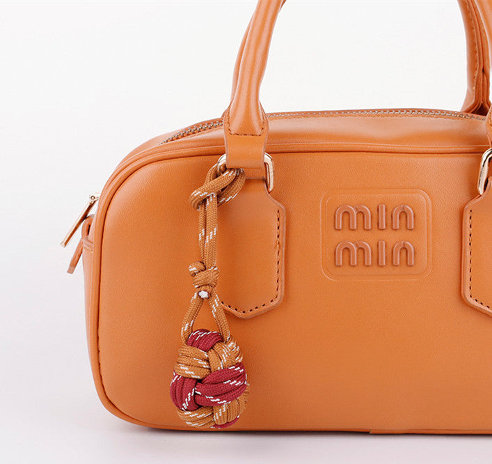 Colorful handmade bag accessory with braided cord