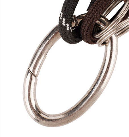Colorful woven rope keychain hanging from a leather backpack strap