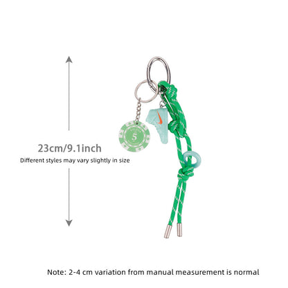 Sporty bag charm hanging from a simple shoulder bag