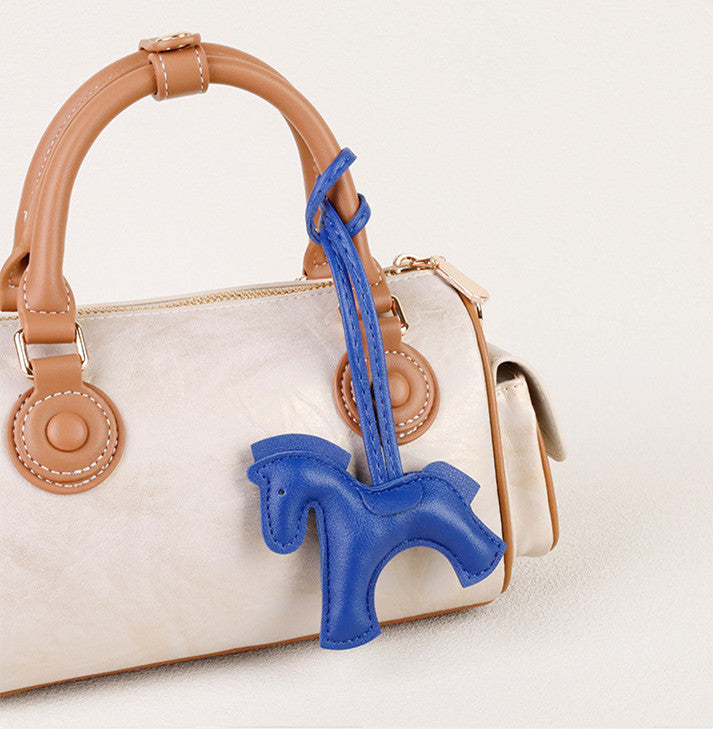 Cute equestrian-inspired charm attached to a tote handle