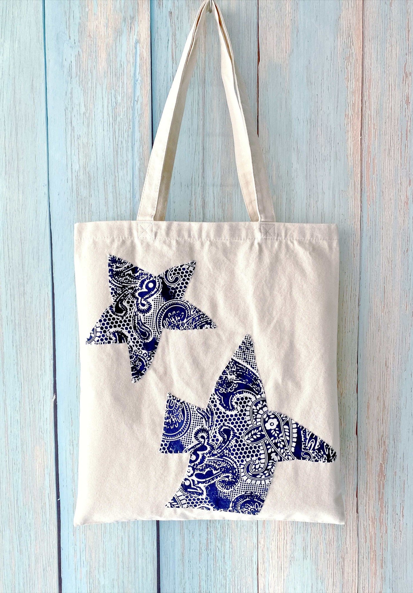 Minimalist outfit pairing with a soft-structured patchwork canvas carryall.