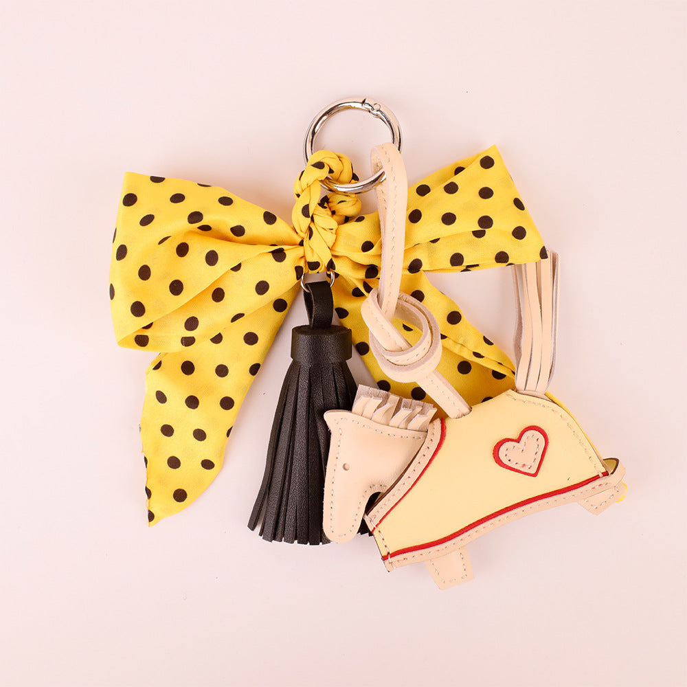 Handmade yellow scarf bow accessory with flowing tassel
