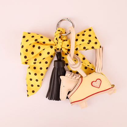 Handmade yellow scarf bow accessory with flowing tassel