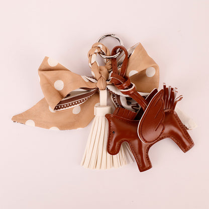 Handmade khaki ribbon charm with a flowing tassel
