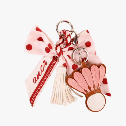 Pink polka dot bow bag charm with scarf-style fabric and tassels