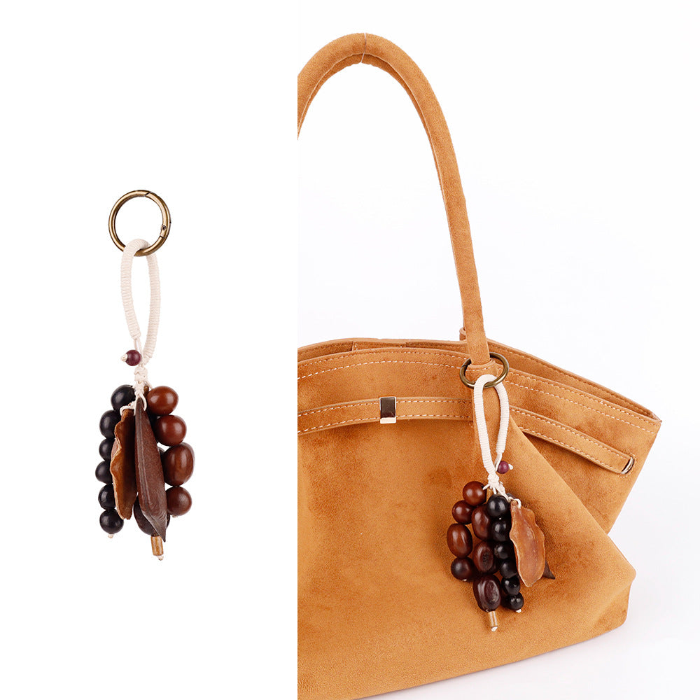 Natural seed pod accessory for a casual handbag