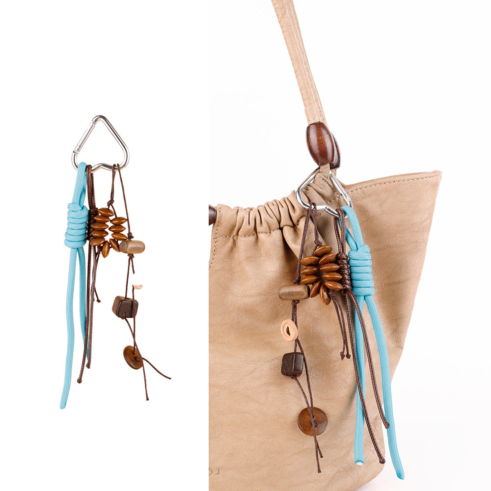 Seed pod and wood bead charm styled as a bag accessory