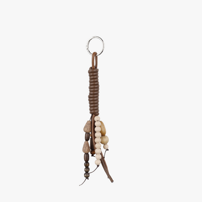 Vintage-style bag charm with a stone bead tassel