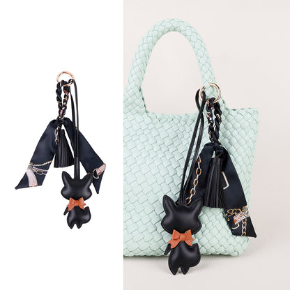 Scarf and tassel details shown against a plain backpack
