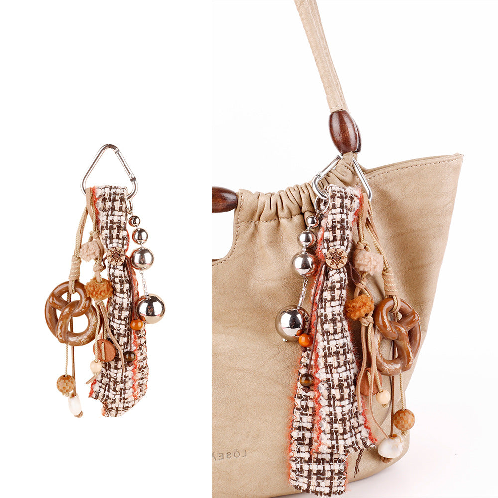 Woven handbag pendant featuring round wooden beads