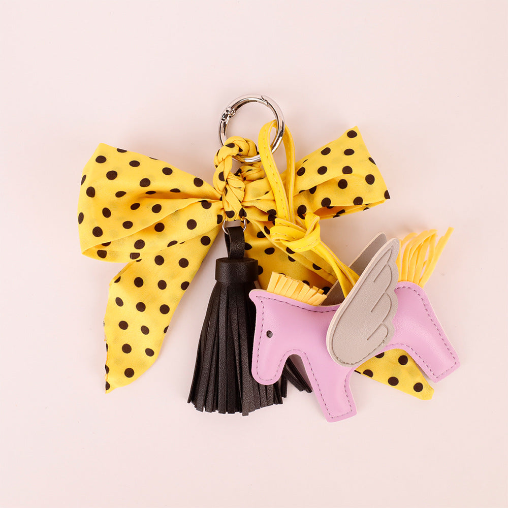 Yellow bow accessory with scarf detail and tassel