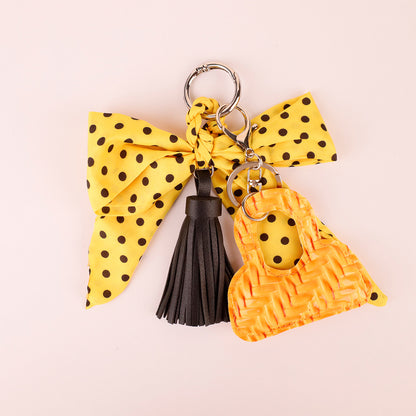 Yellow polka dot bow with a long decorative tassel