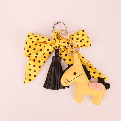 Scarf bow accessory for adding detail to a handbag