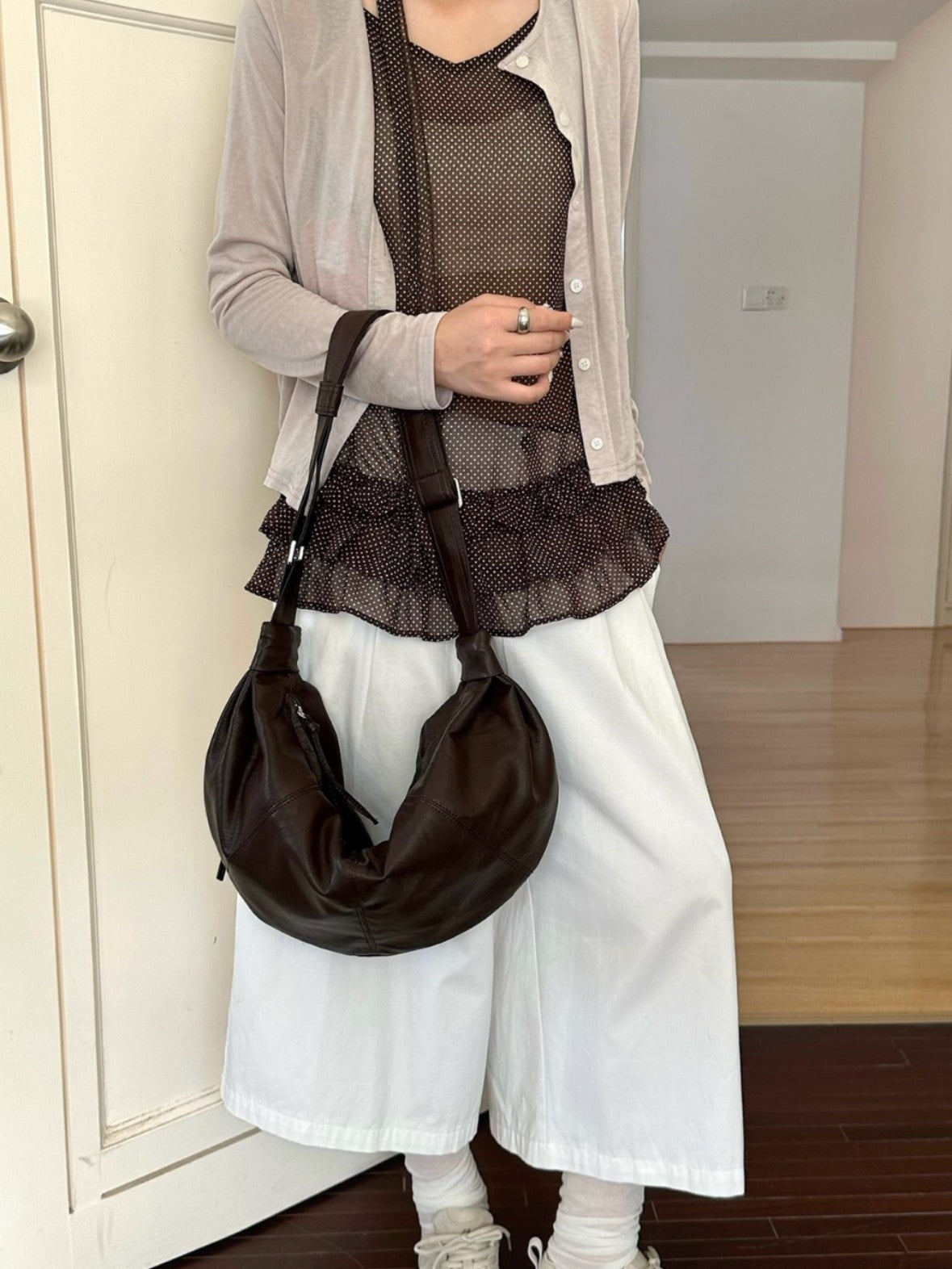 Curved women's bag for carrying essentials on shopping days.