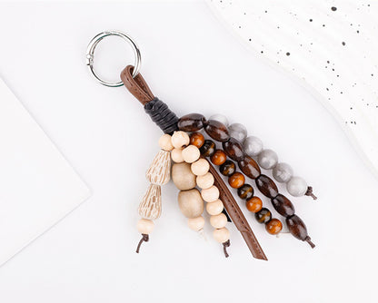Textured bead accessory hanging from a canvas tote handle