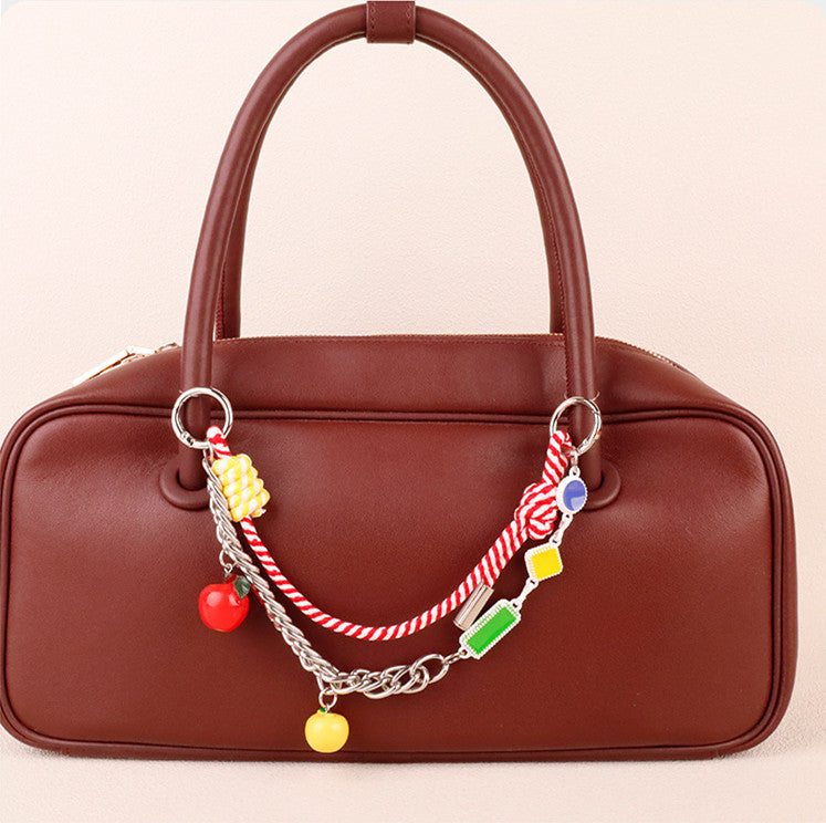 Layered dopamine aesthetic purse accessory hanging on a mini canvas backpack
