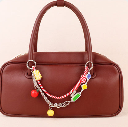 Layered dopamine aesthetic purse accessory hanging on a mini canvas backpack