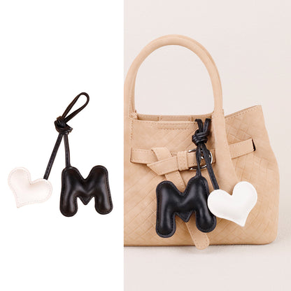 Soft heart-shaped bag decoration with raised filling