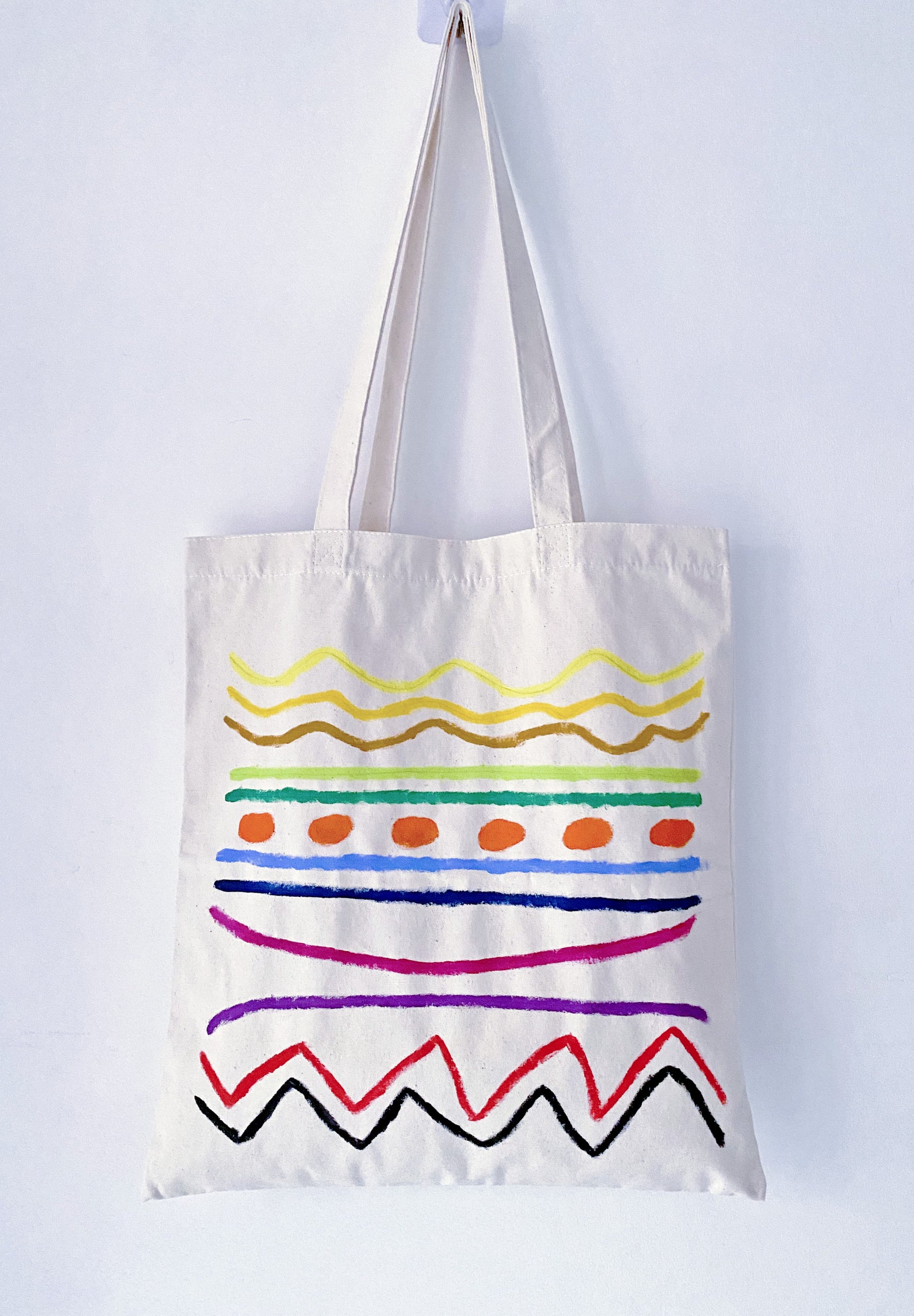 Minimalist aesthetic outfit featuring a spacious hand-painted fabric bag.