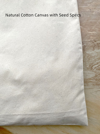 Folded canvas tote bag showing its portability and soft natural material.