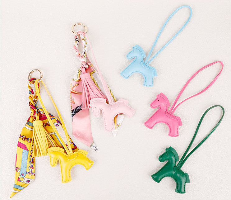 Horse-themed hanging accessory for a casual shoulder bag