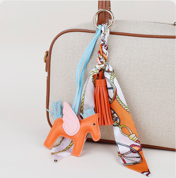 Close-up of fine stitching and silky tassel trim on a custom horse purse charm gift