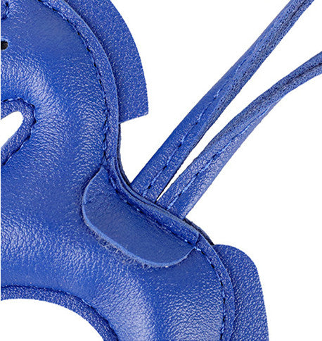 Charming horse ornament clipped onto a backpack