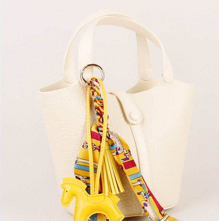 Small horse ornament with colorful scarf and tassel