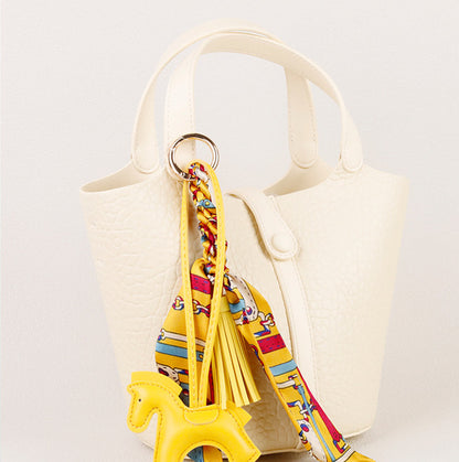 Small horse ornament with colorful scarf and tassel