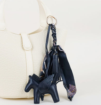 Unique equestrian purse accessory clip attached to a classic canvas work tote